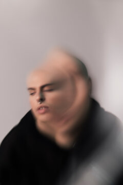 Blurred weird portrait of young man