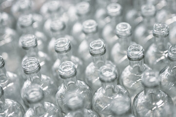 Lines of empty glass bottles for vodka drink in workshop