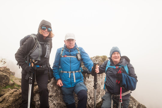 Smiling senior trekkers on the summit