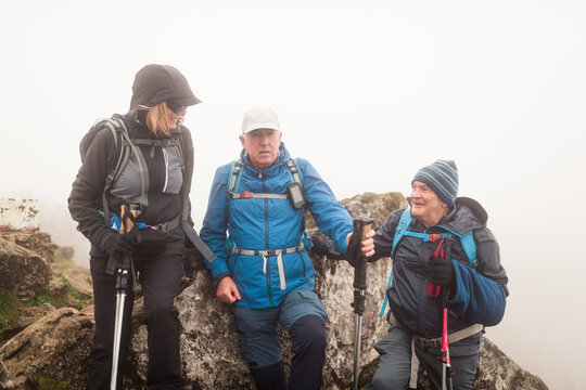 Cheerful senior trekkers on the summit