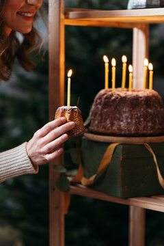 Smiling woman with festive cake in hand.