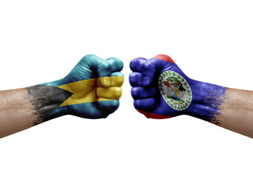 Two hands punch to each others on white background. Country flags painted fists, conflict crisis concept between bahamas and belize