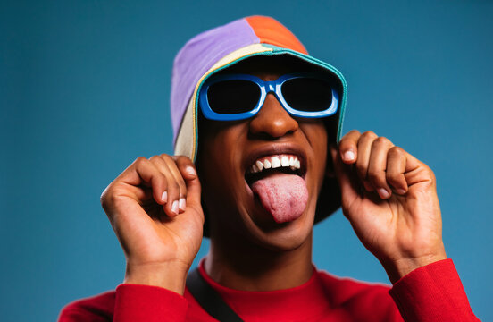 Fashionable black guy showing tongue