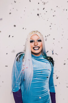 Happy drag queen with bright makeup and confetti