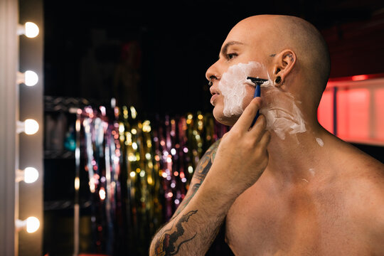 Gay man shaving in a dressing room
