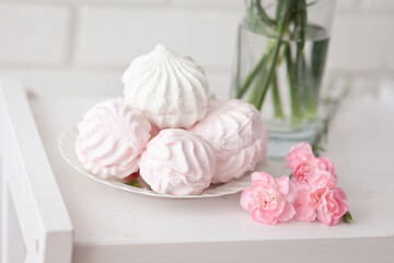 A festive table setting with Pink marshmallows and flowers