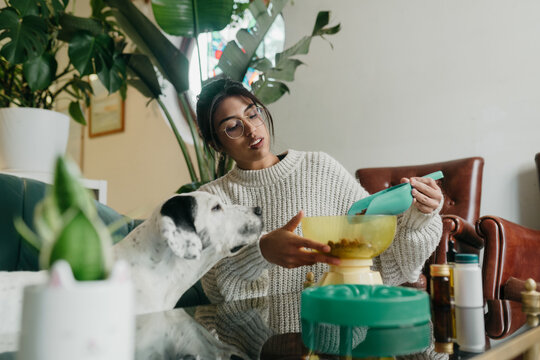 Woman serving dog food