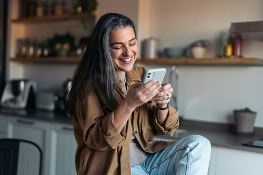 Senior Woman Having Coffee And Using Phone