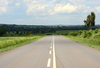 Signposted road and green field