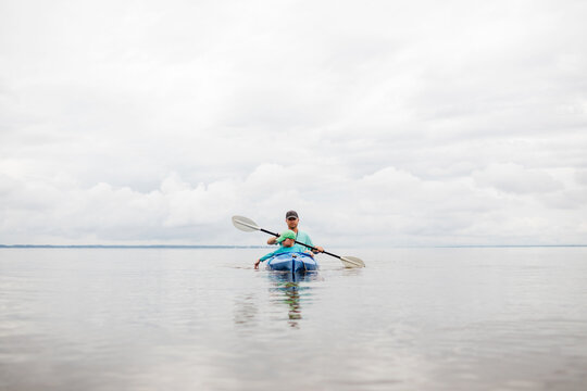 father and son kayak on a lake