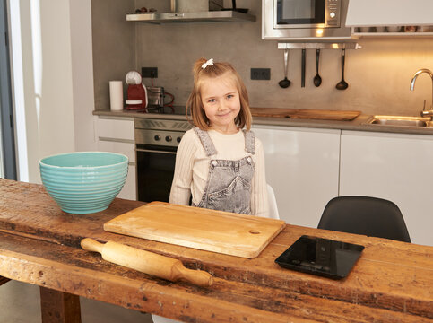 Little girls at kitchen smiling at camera