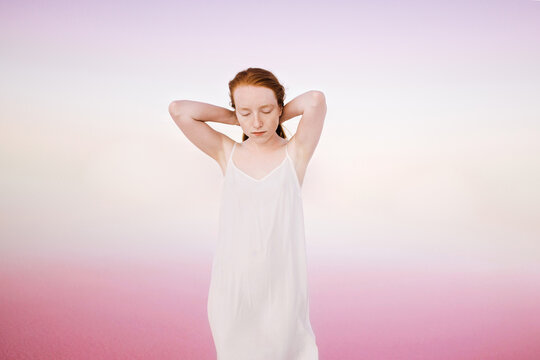 Sensual woman in a white dress in the pink lagoon