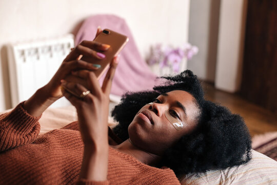 Young woman scrolling on her phone