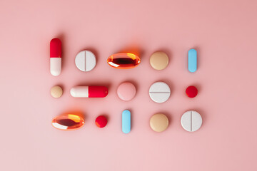 Top view of pills on pink background