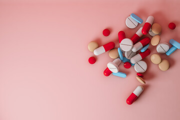 Top view of pills on pink background