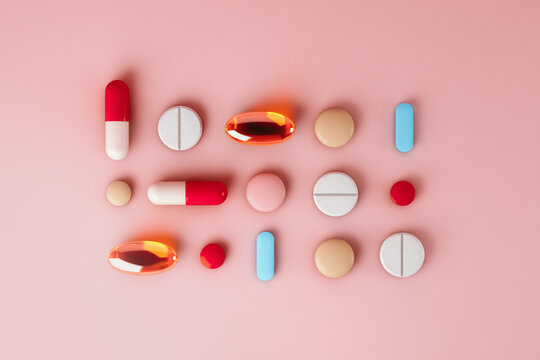 Top view of pills on pink background
