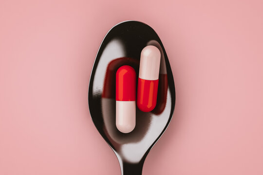 Top view of a spoon with capsule pills