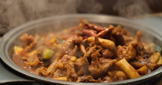close up steaming bullfrog in pot. Delicious spicy bullfrog cuisine. Chinese food. Slow motion