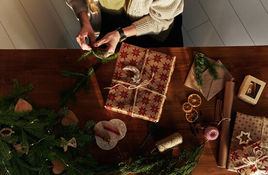 Anonymous woman preparing Christmas gift
