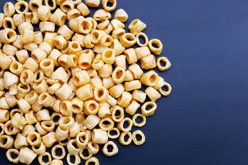 Crispy potato rings on dark background.
