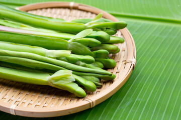 Limnocharis flava in bamboo basket on banana leaf
