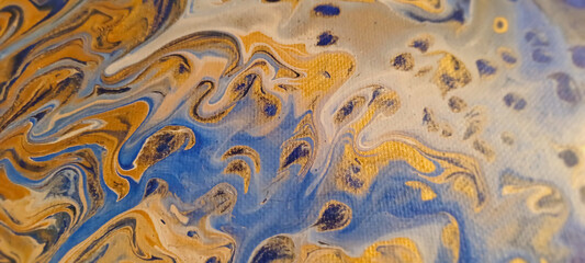 Abstract blue gold yellow art pour painting pattern close-up with canvas texture