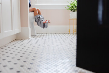child sitting on toilet