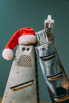 Metal kitchen graters in New Year's suits.