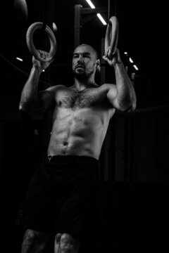 close-up of athlete with abs doing pull-ups