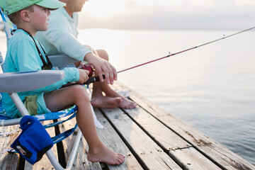 boy and father fishing on a pier