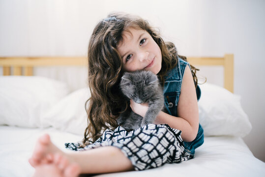 Young Girl holding a gray kitten