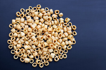 Crispy potato rings on dark background.