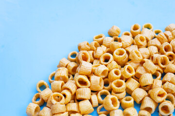 Crispy potato rings on blue background.