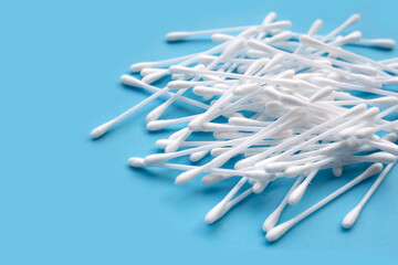 Cotton buds on blue background.