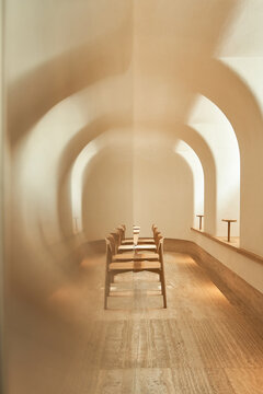 Reflected chairs in sunlit room
