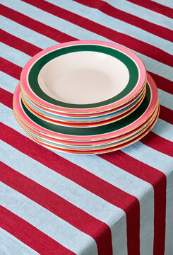 Stack of plates on striped tablecloth