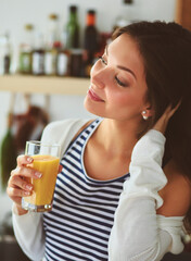 Portrait of a pretty woman holding glass with tasty juice