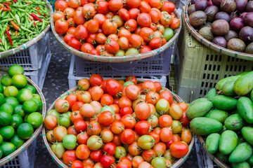 Fresh vegetables and fruits in baskets on street market. Local morning market in Luang Prabang, Laos.