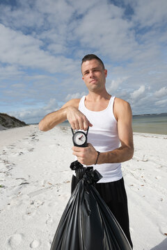 A community volunteer weighing bag full of litter 