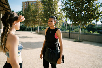 Sportive diverse women meeting in park for training