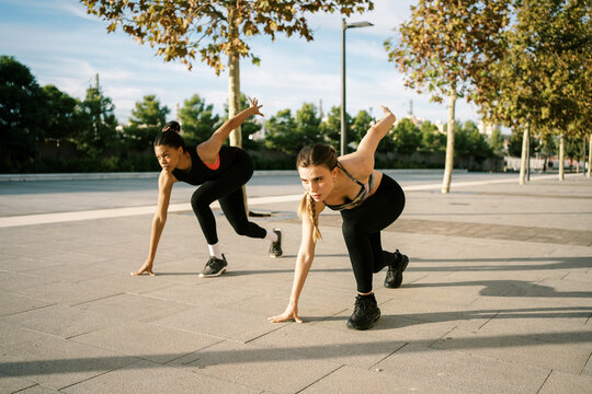 Determined diverse runners standing in ready position