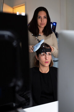 Researcher applying TMS on patient