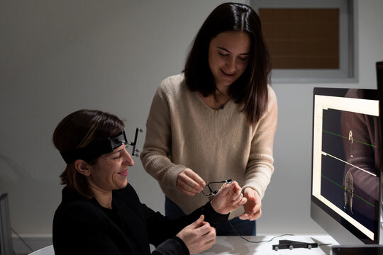 Researcher doing TMS procedure to a patient