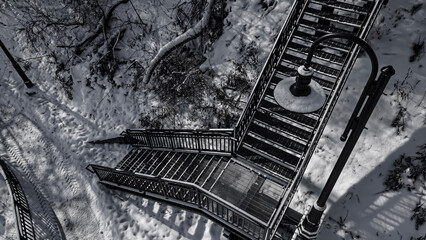 Snow covered urban stairs with snow in black and white