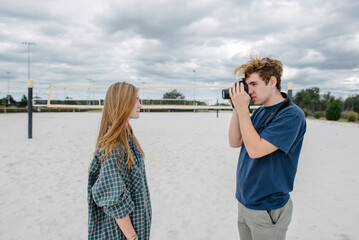 Boy taking pictures of a girl