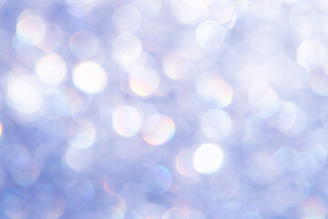 bright glitter background: bokeh effect from many colored lights on frozen glass, toning