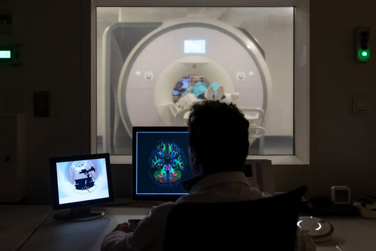 Doctor using computer during MRI procedure