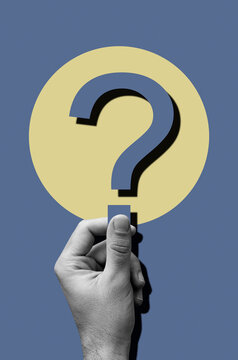 Hand of a man  holding question mark