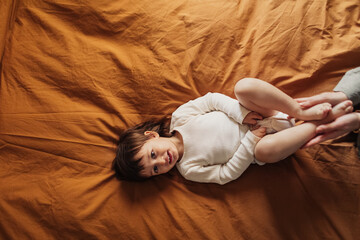 Baby Girl Lying on Bed