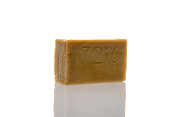 a piece of household soap of 72 percent fat content, highlighted on a white background